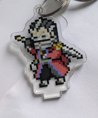 An acrylic charm featuring a pixel Auron