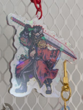 An acrylic charm featuring a pixel Auron