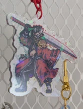 An acrylic charm featuring a pixel Auron