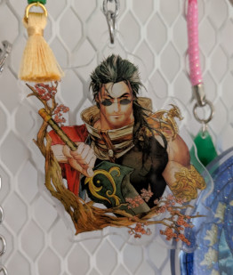 An acrylic charm featuring Auron